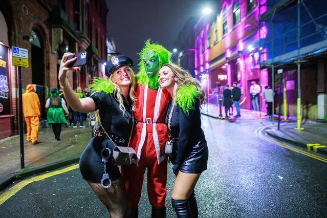 It has become tradition in Wigan in Greater Manchester, United Kingdom for residents to go out on the town in fancy dress for Boxing Day on Sunday, December 26, 2021. Boxing Day is a holiday celebrated after Christmas Day, occurring on the second day of Christmastide. (Photo by Joel Goodman/London News Pictures)