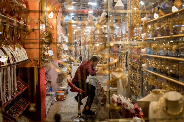 A store owner waits for customers at the Prophet Younis market in East Mosul on November 5, 2017 in Mosul, Iraq. (Photo by Chris McGrath/Getty Images)