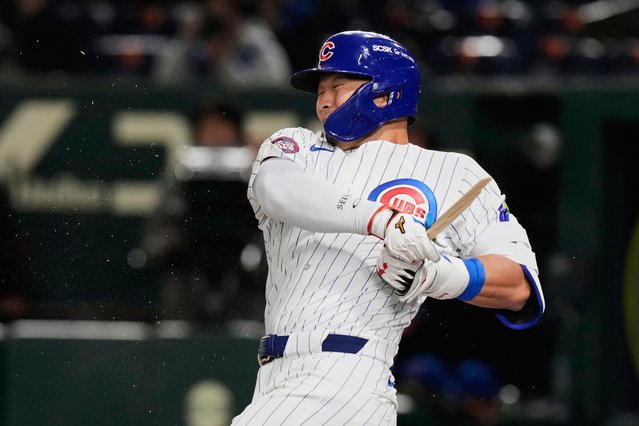 Chicago Cubs' Seiya Suzuki holds on to his broken bat after grounding out in the first inning of an MLB Japan Series baseball game against the Los Angeles Dodgers in Tokyo, Japan, Tuesday, March 18, 2025. (Photo by Eugene Hoshiko/AP Photo)