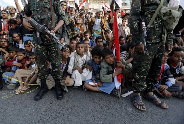 Houthi miilitants stand guard as people watch a ceremony marking the first anniversary of the Houthi movement's takeover of Yemen's capital Sanaa September 21, 2015. (Photo by Khaled Abdullah/Reuters)