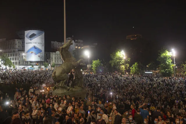 Protesters gather in front of the Serbian parliament in Belgrade, Serbia, Tuesday, July 7, 2020. Thousands of people protested the Serbian president's announcement that a lockdown will be reintroduced after the Balkan country reported its highest single-day death toll from the coronavirus Tuesday. (Photo by Marko Drobnjakovic/AP Photo)