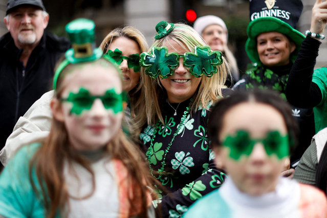 People attend a parade on the day of St Patrick's Festival in London, on March 16, 2025. (Photo by Carlos Jasso/Reuters)