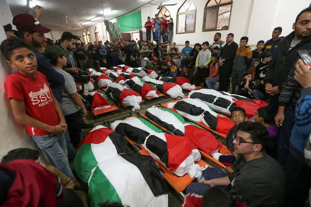 Palestinians attend the funeral of 21 people who were killed in a fire that broke out during a party in the Gaza Strip, according to health and civil emergency officials in the northern Gaza Strip on November 18, 2022. (Photo by Ibraheem Abu Mustafa/Reuters)