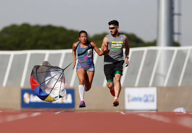 Brazil's Paralympic athlete Terezinha Guilhermina (L) runs alongside her guide Rafael Lazarini during a training session at the Brazilian Paralympic Center in Sao Paulo, Brazil, July 15, 2016. (Photo by Paulo Whitaker/Reuters)