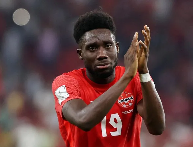 Canada's Alphonso Davies applauds fans after they lost the Qatar 2022 World Cup Group F football match between Canada and Morocco at the Al-Thumama Stadium in Doha on December 1, 2022. (Photo by Ibraheem Al Omari/Reuters)
