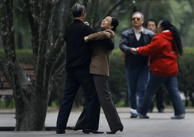 A Chinese woman enjoys a social dance at Ritan Park in Beijing, China Thursday, October 30, 2014. Levels of self-reported well-being in fast-growing nations like Indonesia, China and Malaysia now rival those in US, Germany and the United Kingdom, rich nations which have long topped the happiness charts, according to a Pew Research Center global survey released Friday that it showed how national income was closely linked to personal life satisfaction. (Photo by Andy Wong/AP Photo)