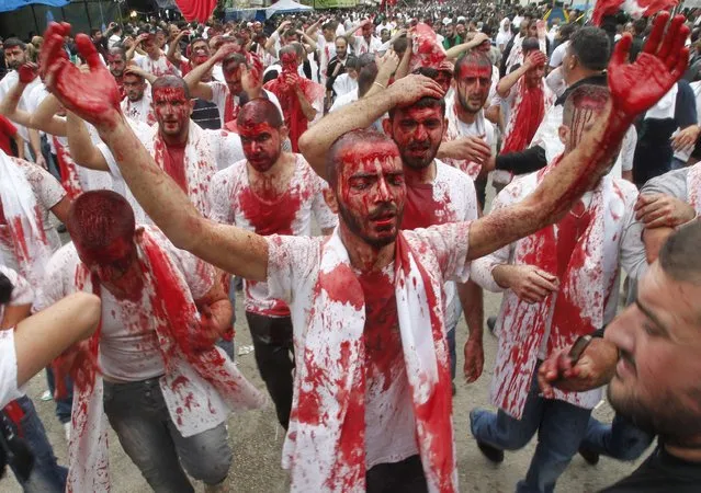 Shi'ite Muslims bleed after tapping their foreheads with a razor during a Muharram procession to mark Ashoura in Nabatieh town, southern Lebanon November 4, 2014. (Photo by Ali Hashisho/Reuters)