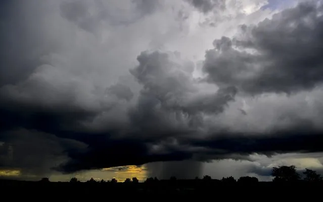 Storm clouds gather above in Debrecen, Hungary, 18 June 2020. (Photo by Zsolt Czegledi/EPA/EFE)