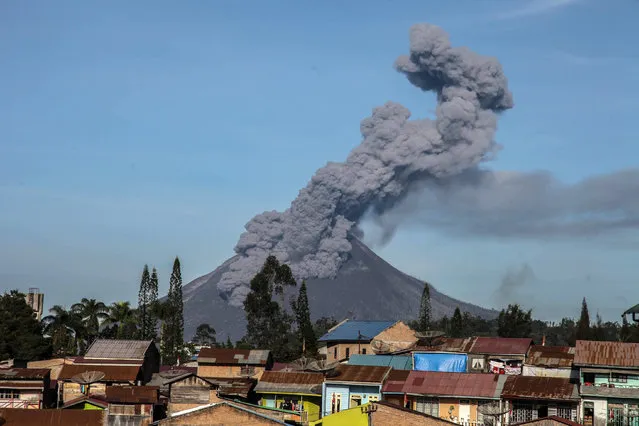 Mount Sinabung continues spew ash volcanic is seen from Berastagi sub-district in Karo Regency, North Sumatera on August 23, 2020. According to The Center for Volcanology and Geological Hazar Mitigation (PVMBG), Mount Sinabung currently at level III and appeals to the community not to carry out activities in the village that have been relocated. (Photo by Albert Ivan Damanik/Anadolu Agency via Getty Images)