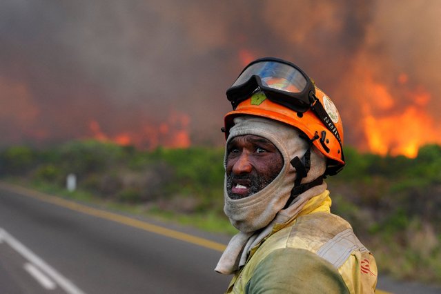 A firefighter battles a mountain fire burning across large areas of the Table Mountain National Park, in Silvermine, Cape Town, South Africa on April 27, 2025. (Photo by Nic Bothma/Reuters)