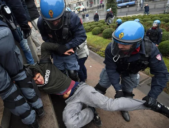 Police officers drag away a man during a demonstration in Milan, Italy, Saturday, February 24, 2018. Thousands of police have been deployed for protests in Rome, Milan and other Italian cities tasked with preventing clashes during an election campaign that has increasingly been marked by violence. At least a dozen marches, rallies or other protests were underway or about to start in several cities Saturday, on the last weekend that political rallies are allowed before the March 4 elections. (Photo by Daniel Dal Zennaro/ANSA via AP Photo)