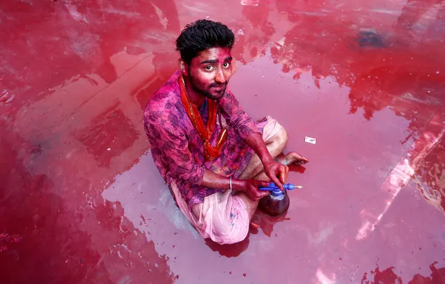 A Hindu devotee takes part in the religious festival of Holi inside a temple in Nandgaon village, in the state of Uttar Pradesh, India February 25, 2018. (Photo by Adnan Abidi/Reuters)
