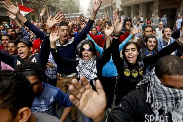 People shout anti-Muslim Brotherhood slogans during a march from downtown to the main Brotherhood headquarters in Cairo, Egypt, on March 22, 2013. Thousands of protesters from  the city are marching to express their rejection of the Muslim Brotherhood and President Mohammed Morsi's rule. (Photo by Amr Nabil/Associated Press)
