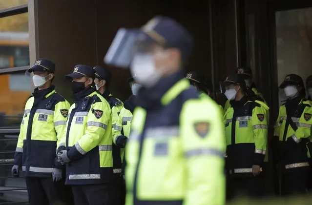 South Korean police officers wearing face masks as a precaution against the coronavirus, stand guard in Seoul, South Korea, Friday, October 30, 2020. (Photo by Lee Jin-man/AP Photo)