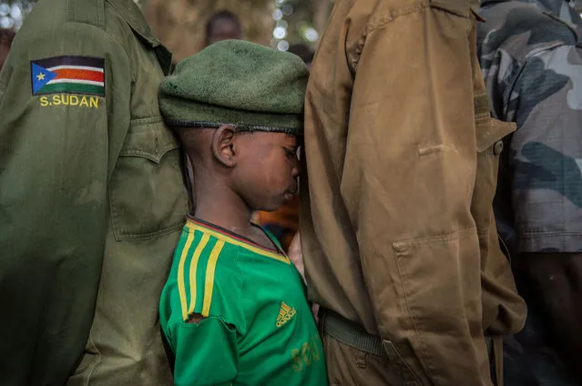 Newly released child soldiers wait in a line for their registration during the release ceremony in Yambio, South Sudan on February 7, 2018. (Photo by Stefanie Glinski/AFP Photo)