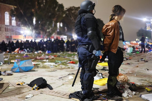 A California Highway Patrol (CHP) officer detains a protestor while clearing a pro-Palestinian encampment after dispersal orders were given at the University of California, Los Angeles (UCLA) campus, on May 2, 2024 in Los Angeles, California. The camp was declared ‘unlawful’ by the university and over 100 protestors who refused to leave were detained during the operation. Pro-Palestinian encampments have sprung up at college campuses around the country with some protestors calling for schools to divest from Israeli interests amid the ongoing war in Gaza. (Photo by Mario Tama/Getty Images)