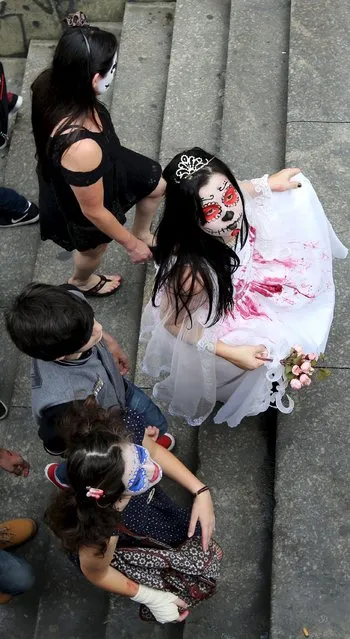 Revellers attend the "Zombie Walk" parade in Sao Paulo, Brazil, November 2, 2015. (Photo by Paulo Whitaker/Reuters)