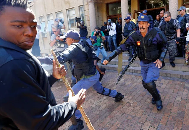 University of Cape Town students clash with police as stun grendes are used during protests demanding free tertiary education in Cape Town, South Africa, October 17, 2016. (Photo by Mike Hutchings/Reuters)