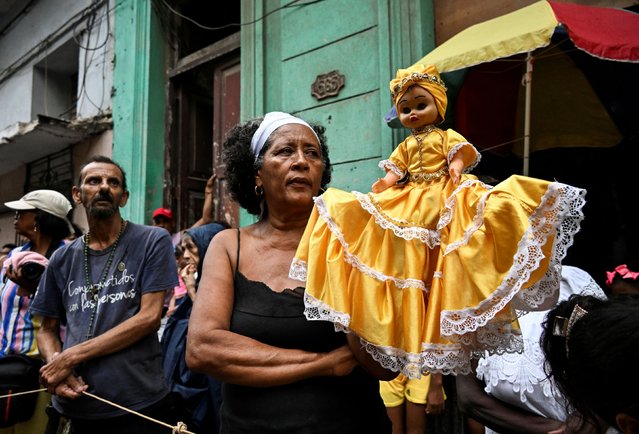 A follower of the Virgin of Charity, Oxun in the Yoruba religion, carry a doll as they attend a procession during the Oxun Day celebrations in havana on September 8, 2025. (Photo by Yamil Lage/AFP Photo)