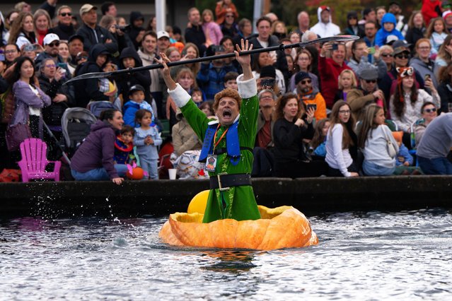 Gary Kristensen, dressed up as the character Buddy from the holiday movie “Elf”, celebrates after winning a race during the West Coast Giant Pumpkin Regatta in Tualatin, Ore., October 19, 2025. (Photo by Jenny Kane/AP Photo)