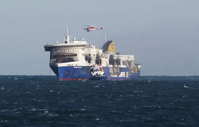 The car ferry Norman Atlantic is drawn by tug boats on its way to Brindisi harbour, after a fire in waters off Greece January 2, 2015. The ferry caught fire off Greece's Adriatic Coast on December 28, 2014 while on a voyage to Italy. (Photo by Ciro De Luca/Reuters)