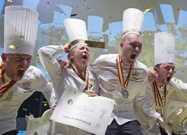 Members of the National team of Sweden celebrate after winning the category “Junior teams” during the medal ceremony of the International Exhibition of Culinary Art (IKA) also known as the Culinary Olympics IKA in Erfurt , Germany, Wednesday, October 26, 2016. (Photo by Jens Meyer/AP Photo)