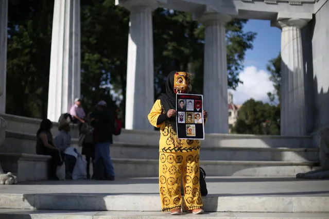 An activist takes part in a demonstration in support of the 43 students missing from Ayotzinapa College Raul Isidro Burgos as she protests to demand justice for the missing students, during a meeting to mark the 25-month anniversary of their disappearance, at Hemiciclo a Juarez monument in Mexico City, Mexico, October 26, 2016. (Photo by Edgard Garrido/Reuters)