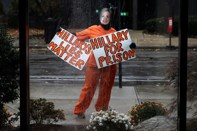 A person wearing an orange jumpsuit and dressed as Hillary Clinton stands outside the venue of U.S. Republican presidential nominee Donald Trump's campaign event in Manchester, New Hampshire, U.S., October 28, 2016. (Photo by Carlo Allegri/Reuters)