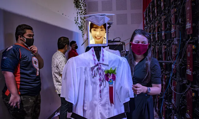 The face of a graduating student is displayed on a tablet attached to a robot during a “cyber graduation” ceremony at a school on May 22, 2020 in Taguig, Metro Manila, Philippines. Robots represented some 179 graduating students of the Senator Rene Cayetano Science and Technology High School during a graduation ceremony that was streamed online, as mass gatherings remain prohibited in the country under the Philippine government's lockdown to curb the spread of the coronavirus. The robots were developed by alumni of the school's robotics club, which used tablets to display the faces of the graduating students as they “marched” on stage to receive their diplomas. The Philippines' Department of Health has so far reported 13,434 cases of the coronavirus in the country, with at least 846 recorded fatalities. (Photo by Ezra Acayan/Getty Images)