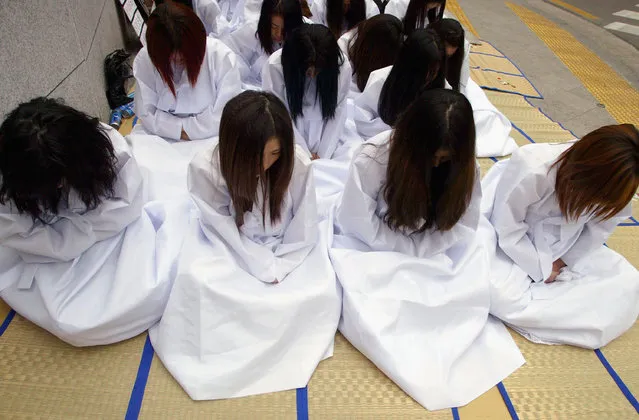 SEOUL, SOUTH KOREA - DECEMBER 6: South Korean prostitutes dressed in funeral robes, hold an anti-government rally in front of the Integrated Government Building on December 6 2004 in Seoul, South Korea. The South Korean government began enforcing new laws to target human traffickers, pimps and prostitutes. Protesters rallied on Monday to protest against the government's strengthened anti-s*x industry laws. (Photo by Chung Sung-Jun/Getty Images)