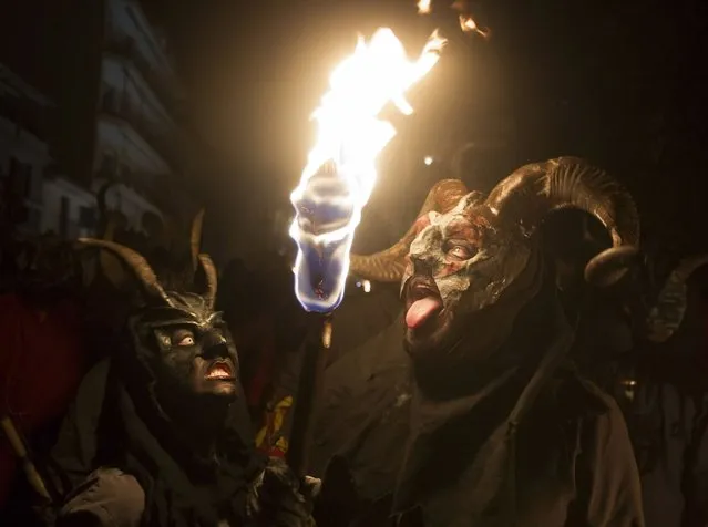 Revellers wearing a demon costume take part in the traditional festival of “Correfoc” in Palma de Mallorca, on January 17, 2015. (Photo by Jaime Reina/AFP Photo)