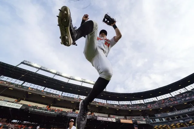 Baltimore Orioles center fielder Austin Hays leaps while taking the field prior to the first inning of a baseball game against the Cleveland Guardians, Tuesday, May 30, 2023, in Baltimore. (Photo by Julio Cortez/AP Photo)