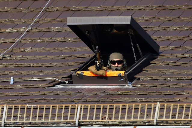 A sniper of the German police takes position on the day German President Frank-Walter Steinmeier welcomes U.S. President Joe Biden at Bellevue Palace in Berlin, Germany, on October 18, 2024. (Photo by Fabrizio Bensch/Reuters)