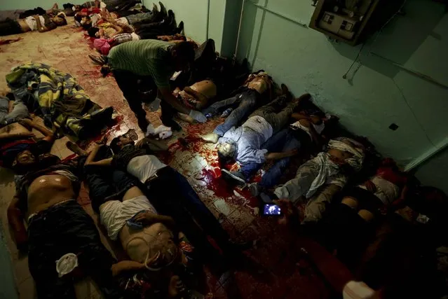 Bodies lie in a room of a hospital after being shot and killed  outside the Republican Guard building in Nasser City, Cairo, on July 8, 2013. Egyptian soldiers and police opened fire on supporters of the ousted president outside the military building in Cairo where demonstrators had been holding a sit-in, government officials and witnesses said. (Photo by Wissam Nassar/Associated Press)