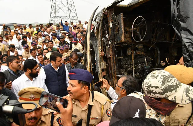 This photo provided by Maharashtra state Chief Minister's Office shows chief Minister Eknath Shinde, front in white, and Deputy chief Minister Devendra Fadnavis visit the site of a bus accident in Buldhana district of Maharashtra state, India, Saturday, July 1, 2023. A tire blowout caused the bus to lose control and crash into a road divider and burst into flames, killing 25 people early Saturday, police told local media. (Photo by Maharashtra state Chief Minister's Office via AP Photo)