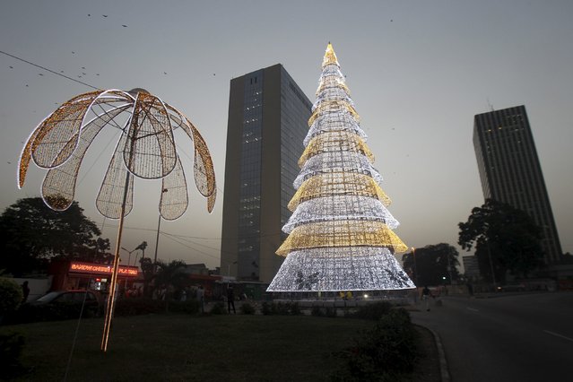 An illuminated Christmas tree stands in Plateau, the central business district of Abidjan, Ivory Coast, December 16, 2015. (Photo by Luc Gnago/Reuters)