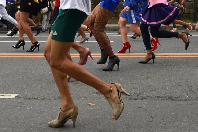 Participants wearing stilettos run as they compete in the “Tour De Takong” stiletto race, as part of activities for the town's annual shoe festival, along Shoe Avenue in Marikina city, Metro Manila, Philippines November 26, 2016. (Photo by Ezra Acayan/Reuters)
