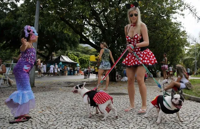 Carnival revellers and dogs take part in the “Blocao” or dog carnival parade during carnival festivities in Rio de Janeiro February 14, 2015. (Photo by Sergio Moraes/Reuters)