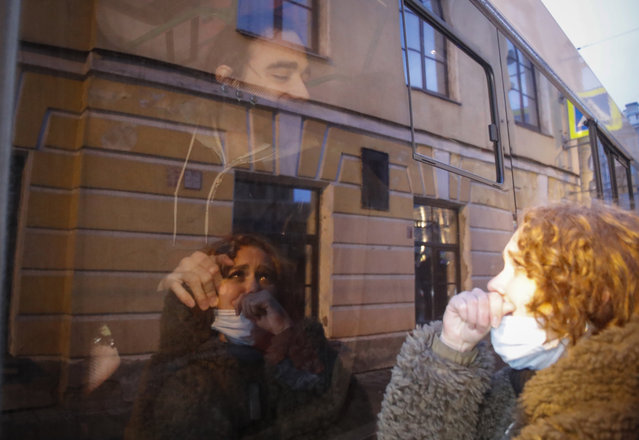 A detained protestor looks on from inside a police van during a protest in support of jailed opposition leader Alexei Navalny in St. Petersburg, Russia, Wednesday, April 21, 2021. A human rights group that monitors political repressions said at least 400 people were arrested across the country in connection with the protests. Many were seized before protests even began, including two top Navalny associates in Moscow. (Photo by Dmitri Lovetsky/AP Photo)