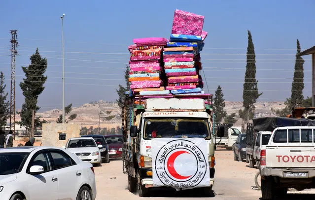 A Red Crescent vehicle carries mattresses for Syrians evacuating the eastern districts of Aleppo, in a government held-area in Aleppo, Syria in this handout picture provided by SANA on November 27, 2016. (Photo by Reuters/SANA)