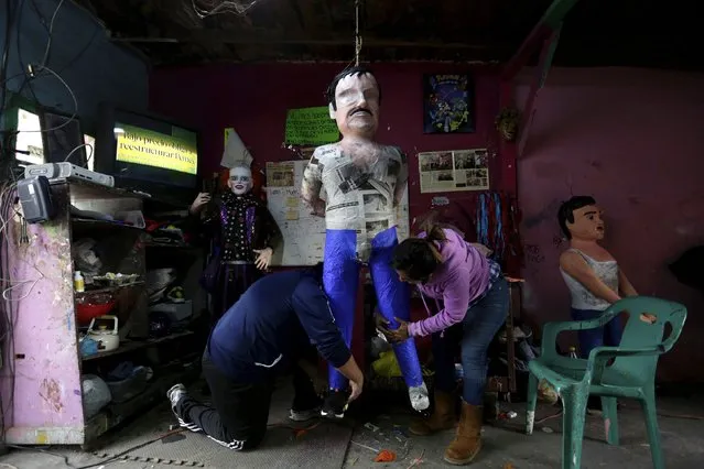 Artisans work on a pinata depicting the drug lord Joaquin "El Chapo" Guzman at a workshop in Reynosa, in Tamaulipas state, Mexico, January 13, 2016. (Photo by Daniel Becerril/Reuters)