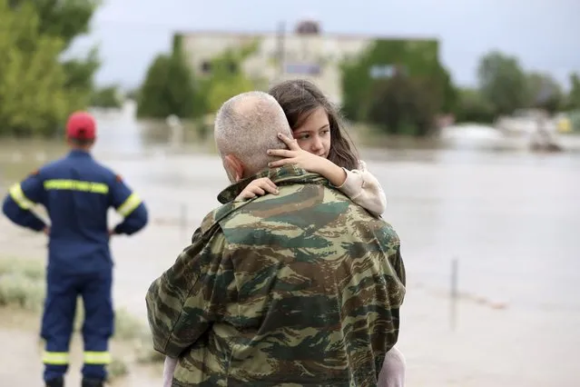 Ilias Chatziliadis holds his daughter Georgia after firefighters helped her evacuate a flooded building in Larissa, central Greece, Wednesday, September 6, 2023. Fierce rainstorms are battering neighboring Greece, Turkey and Bulgaria, causing at least seven deaths.Fierce rainstorms are battering neighboring Greece, Turkey and Bulgaria, causing several deaths.(Photo by Vaggelis Kousioras/AP Photo)