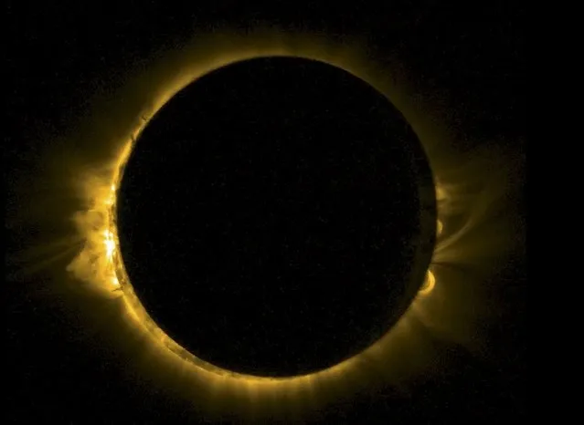 A solar eclipse is viewed by ESA's Sun-watching Proba-2 minisatellite, using it's SWAP imager to capture the Moon passing in front of the Sun in a near-totality, in this handout image provided by the Royal Observatory of Belgium March 20, 2015. SWAP views the solar disc at extreme ultraviolet wavelengths to capture the turbulent surface of the Sun and its swirling corona. (Photo by Reuters/ESA/Royal Observatory of Belgium)