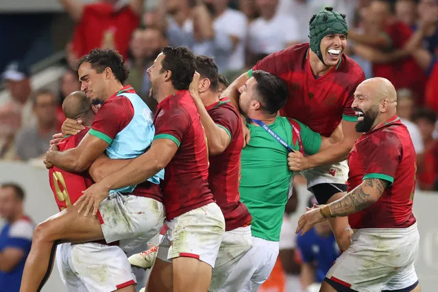 Portugal's flanker David Wallis (2R) and Portugal's hooker Mike Tadjer (R) celebrate with teammates after victory in the France 2023 Rugby World Cup Pool C match between Fiji and Portugal at the Stade de Toulouse in Toulouse, southwestern France on October 8, 2023. (Photo by Charly Triballeau/AFP Photo)