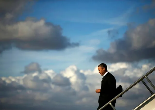 President Barack Obama steps off Air Force Oneupon his arrival at Miami International Airport, Friday, November 8, 2013, in Miami. Obama traveled to the south Florida area for three Democratic fundraisers. (Photo by Pablo Martinez Monsivais/AP Photo)