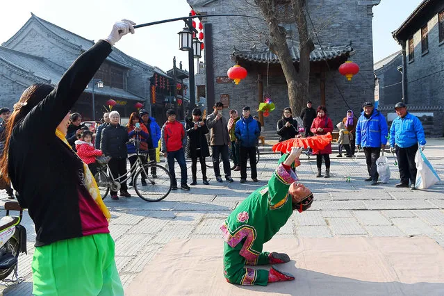 A folk artist performs at a tourist area, ahead of the Chinese New Year, in Weifang, Shandong province, February 3, 2016. (Photo by Reuters/China Daily)