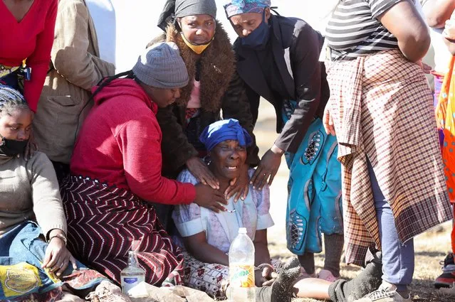 Amelia Dlamini, grandmother of 15-year-old Vusi Dlamini reacts next to his body after he has been allegedly shot outside a mall where looting was taking place, as the country deploys army to quell unrest linked to the jailing of former South African President Jacob Zuma, in Vosloorus, South Africa, July 14, 2021. (Photo by Siphiwe Sibeko/Reuters)