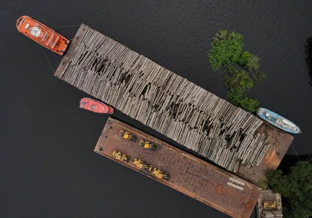 An aerial view show wood logs on a raft at the Federal Police base in Manaus, Amazonas state, Brazil on May 19, 2021. Picture taken with a drone. (Photo by Bruno Kelly/Reuters)