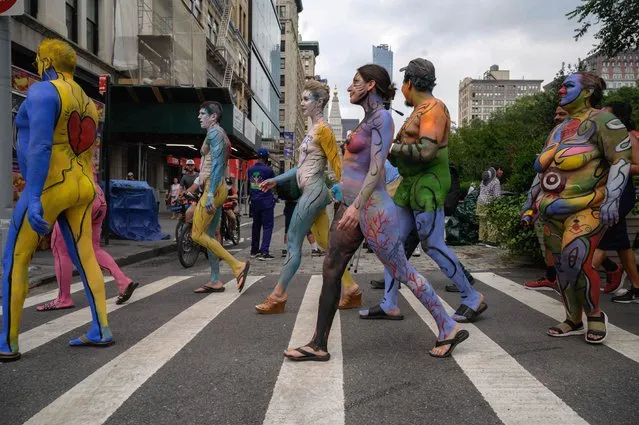 Participants cross a road as they march during the annual NYC Bodypainting Day near Union Square in New York on July 25, 2021. The annual self-titled event aims to promote acceptance and the “use of the human form as an aesthetic versus personal identity”. (Photo by  Ed Jones/AFP Photo)