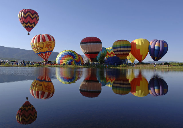 This photo provided by Steamboat Ski Resort shows hot air balloons that visitors can tour in above the town and mountains in Steamboat Springs, Colo. Wild West Adventures offer continental breakfast, champagne ceremony with flight certificates and courtesy pick-up are included. (Photo by Larry Pierce/AP Photo/Steamboat Ski Resort)